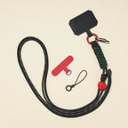 Braided rope phone lanyard in Onyx (black & red), knot-work detail, phone tabs and mini loop.