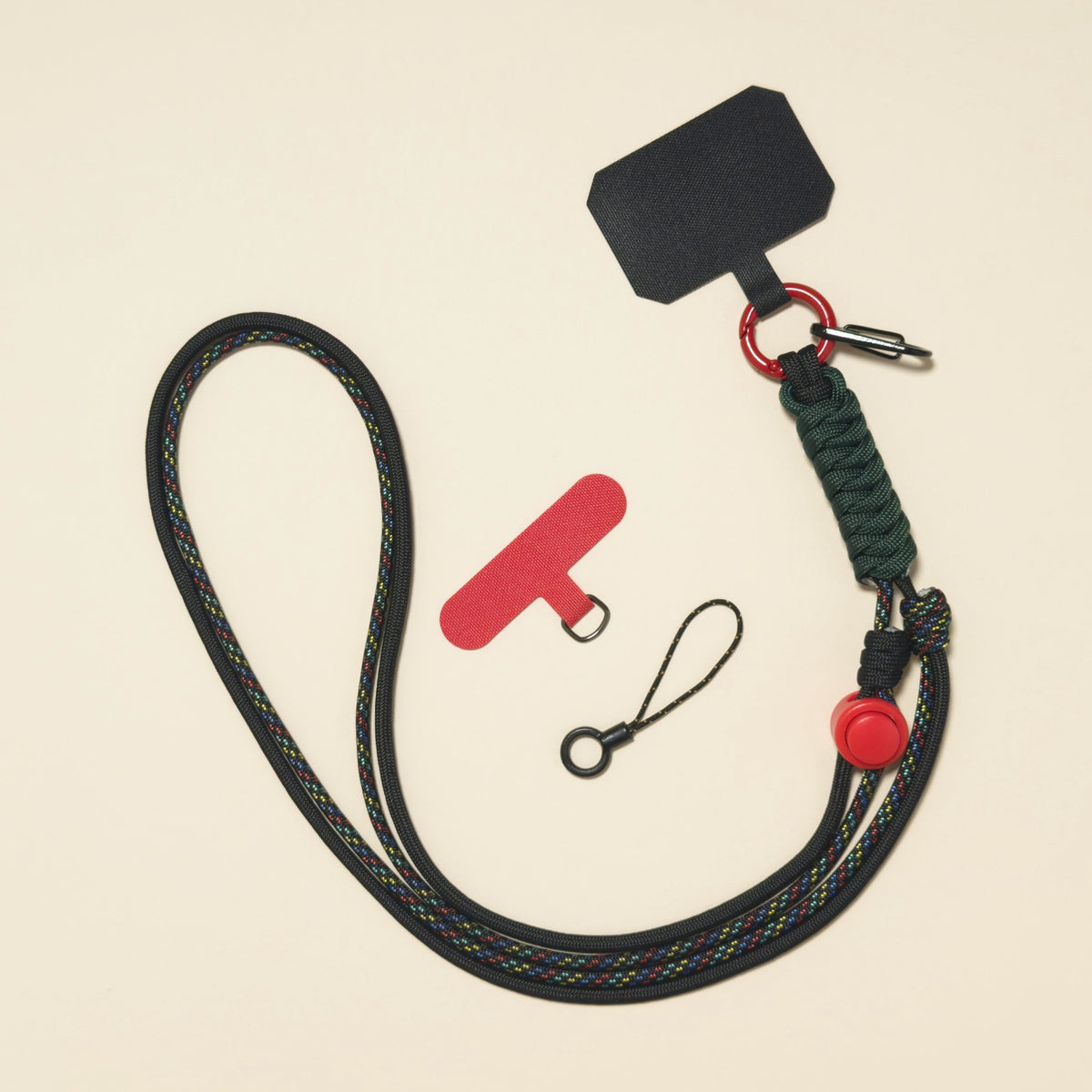 Braided rope phone lanyard in Onyx (black & red), knot-work detail, phone tabs and mini loop.